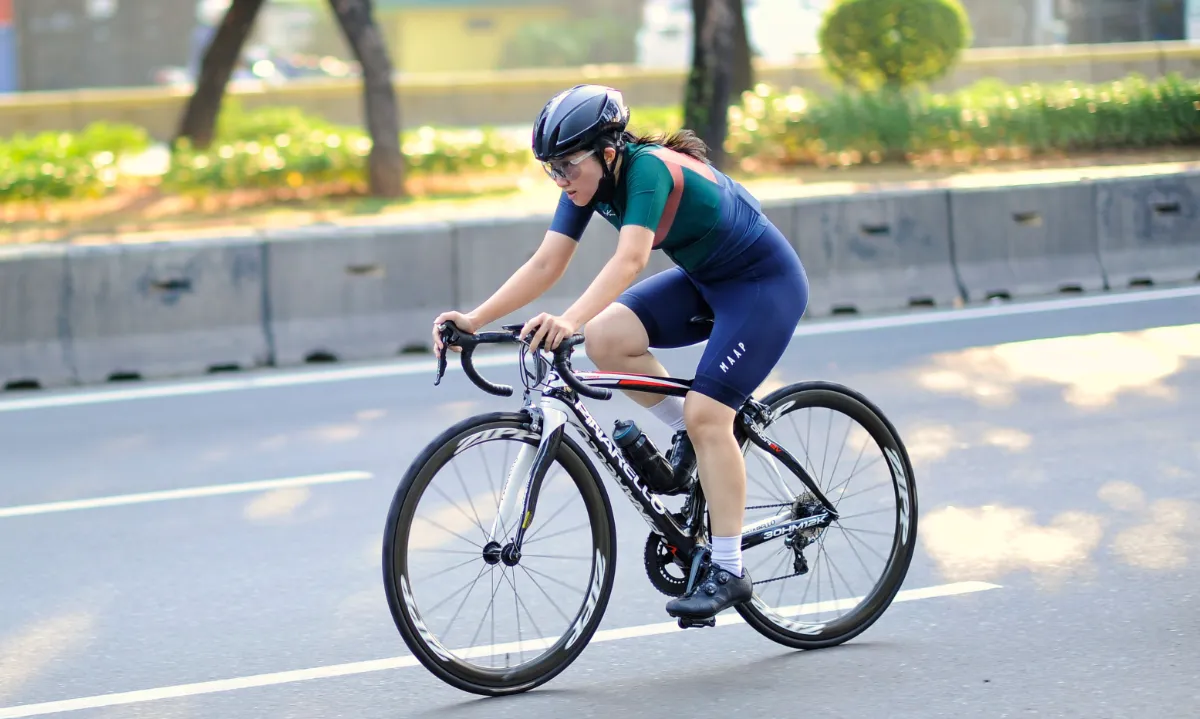 Woman riding bike in the sunshine.