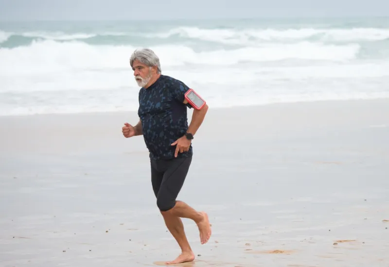 A man is running along the beach.