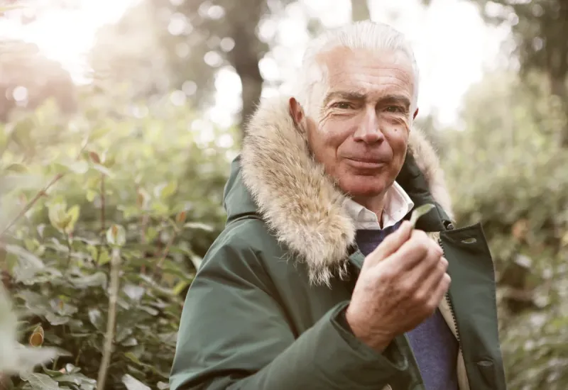Older man outside in the wilderness.