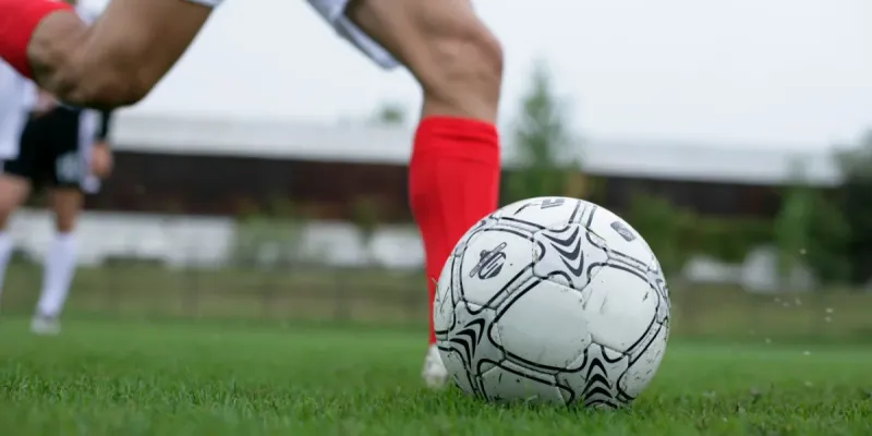 A soccer player kicking the ball.