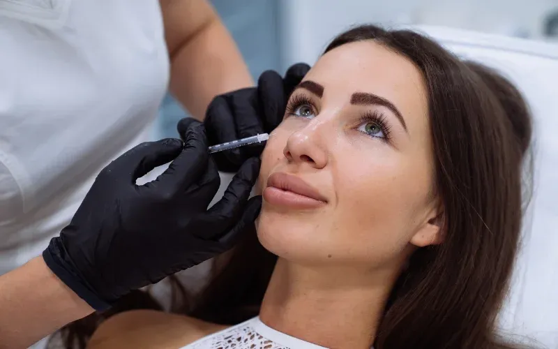 Woman getting dermal filler injections.